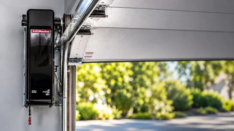 Wall-mount garage door opener beside an open sectional door — garage door repair Tacoma